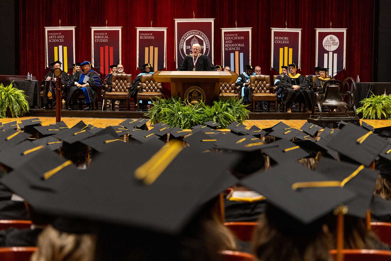 students at commencement with graduation caps