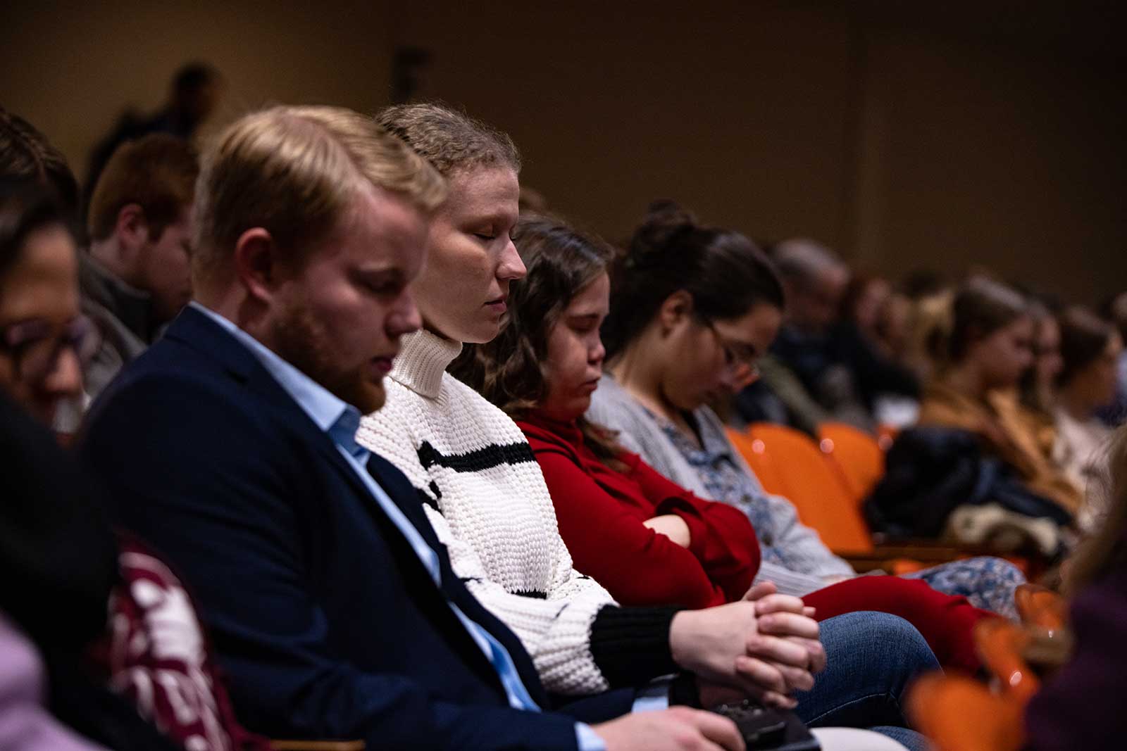 students praying in chapel